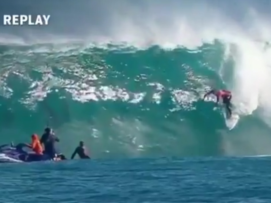 Conner Coffin shares his ride with a pod of dolphins.