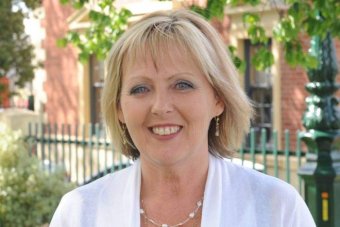 Former councillor Julie Hoskin photographed outside council buildings in Bendigo. She's smiling, wears a white blouse. 