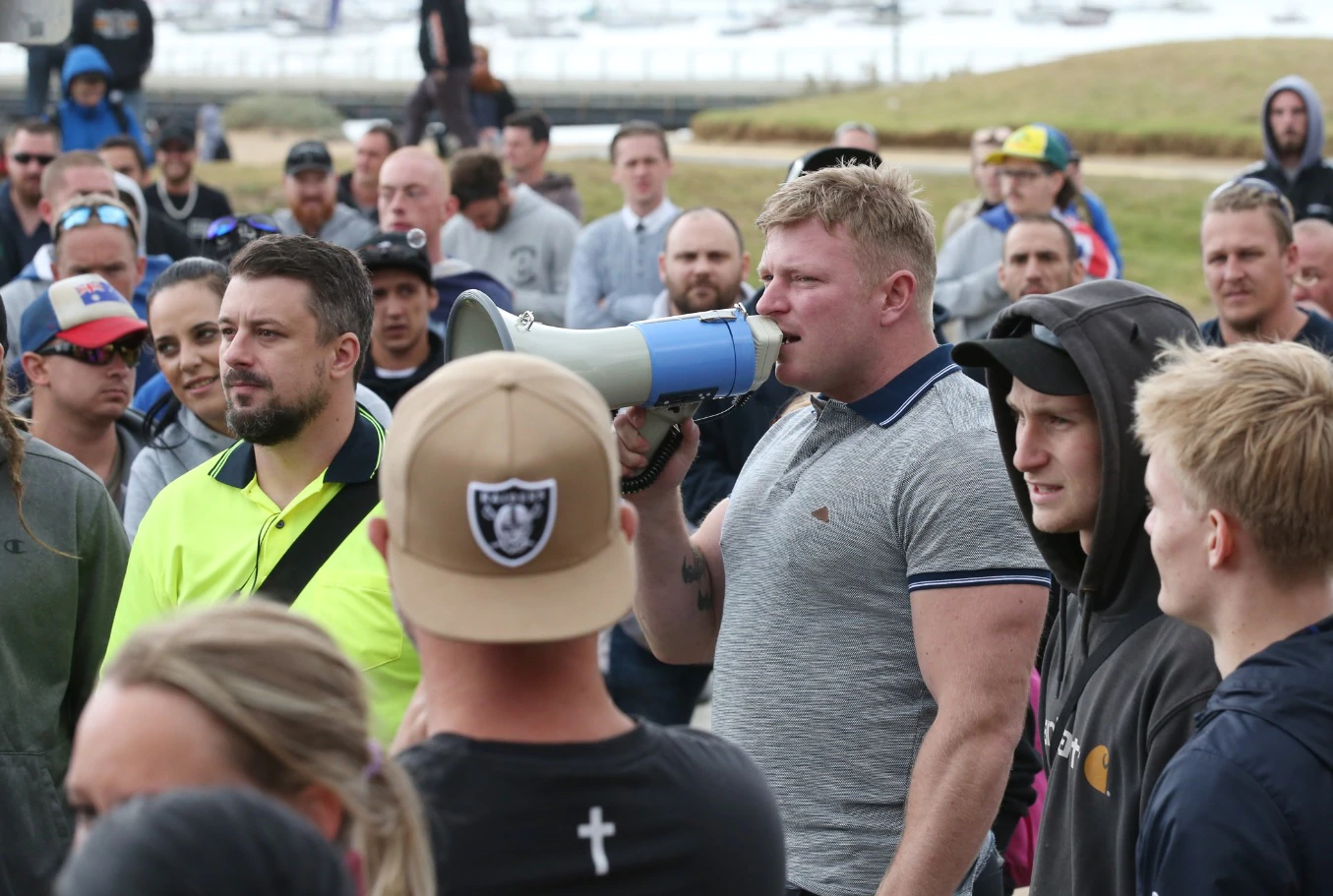 Far right wing activists Neil Erikson (yellow shirt) and Blair Cottrell (3rd right) are seen on St Kilda foreshore in Melbourne, Saturday, January 5, 2019.