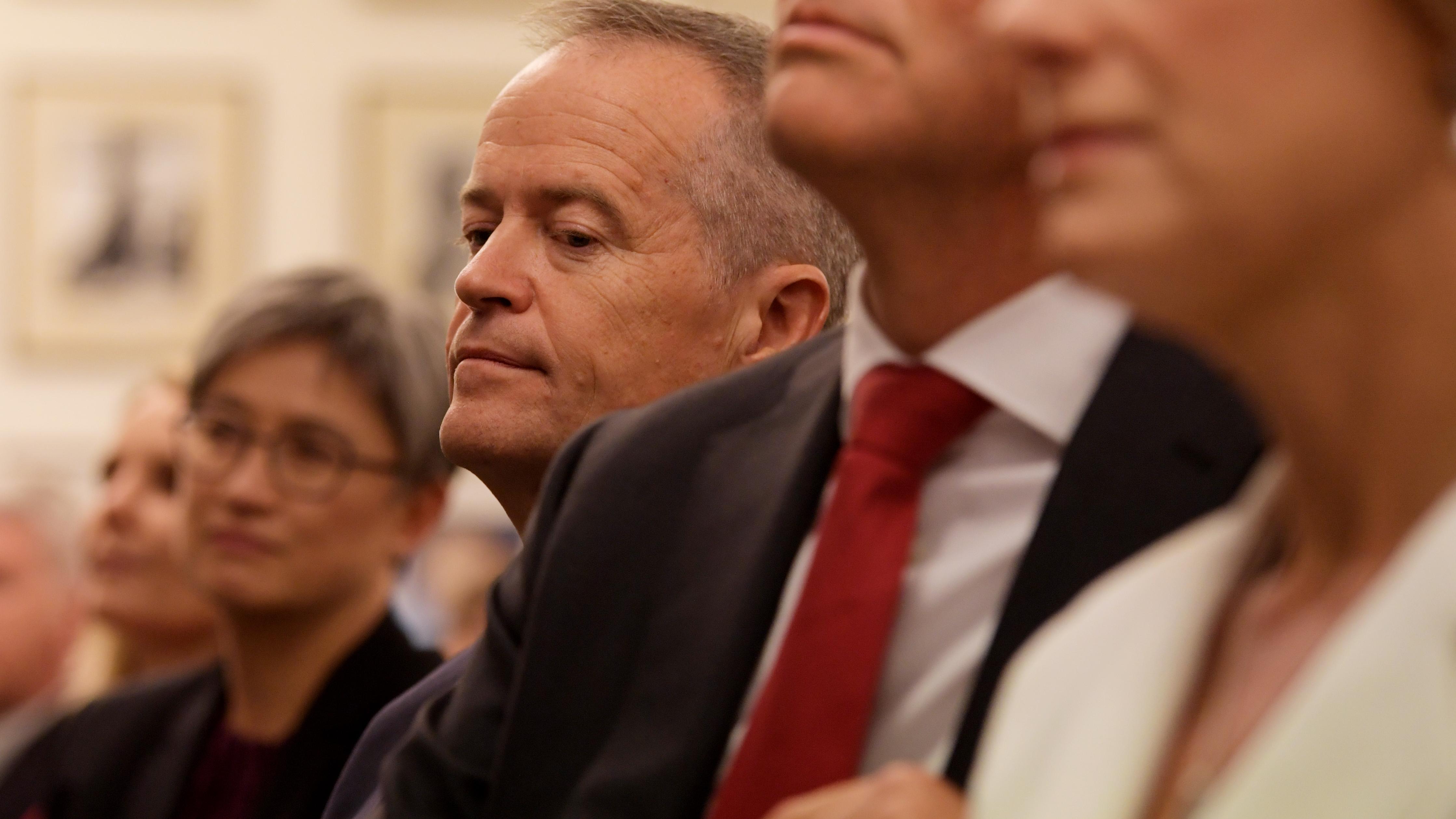 Former leader Bill Shorten listens to new Labor leader Anthony Albanese speak.