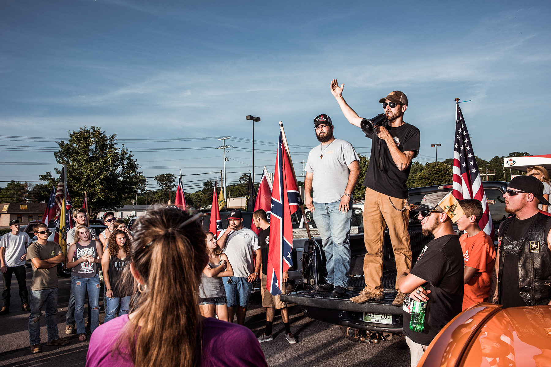Tom Piece, right and Mathew Heimbach, tailgate left, deliver speeches during a confederate flag rally held in a parking lot in Seymour, Tennessee on Thursday, July 17, 2015. After rallying the crowd with talk of their heritage being under attach from the federal government, the two prompted the group to drive with flags raised through Knoxville. Mike Belleme for Al Jazeera America
