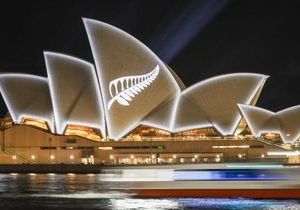 A silver fern projected onto sail structure of Sydney Opera House