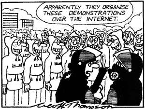 [ Cartoon of massed Internet geeks, with one  cop saying to the other: "Apparently they organise these demonstrations over the internet." ]