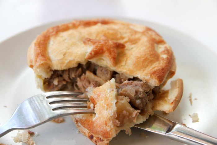 An open pie with a knife and fork