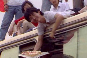 image for article:A man offers cake to passers by in Tiananmen Square in the lead-up to the massacre in 1989. (ABC TV)