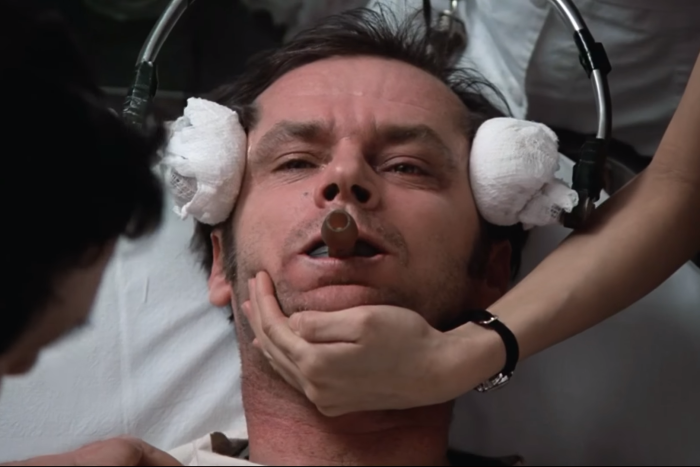 A still from the movie, showing a character with electrodes against his temples.