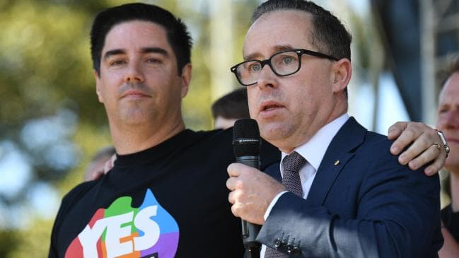 Shane Lloyd (left) the partner of Qantas CEO Alan Joyce (right) was one of the first to do the mental arithmetic and work out the Yes side had won. Picture: AAP Image/David Moir.