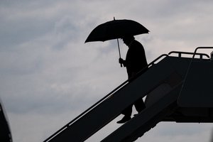 President Donald J. Trump carries an umbrella as he disembarks Air Force One during a rain shower Thursday, May 30, 2019, at Joint Base Andrews, Md.