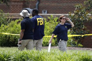 Law enforcement officials work outside a municipal building that was the scene of a shooting, Sunday, June 2, 2019, in Virginia Beach, Va. DeWayne Craddock, a longtime city employee, opened fire at the building Friday before police shot and killed him, authorities said.