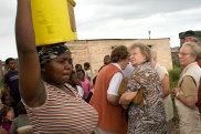 BFDH69 Tourists walk through New Brighton Township, Port Elizabeth, South Africa. Slum tourism, South Africa