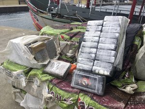 Bales with cocaine seized by Portuguese Police are displayed next to a Brazilian trawler at a Portuguese Navy base in Almada, outside Lisbon, Tuesday, June 4, 2019.