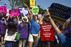 Stephanie Castro, center, celebrates during a rally at the Supreme Court in Washington, Monday, June 27, 2016, after the court struck down Texas' widely replicated regulation of abortion clinics.