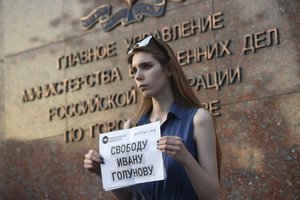 A protester holds a poster reading "Freedom for Ivan Golunov ", with one protester mounting a lone picket protest for detained journalist Ivan Golunov, at Russian Internal Ministry building in Moscow, Russia, Friday, June 7, 2019