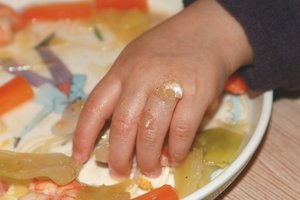 11 December 2015, A child's hand eating.