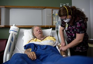 Henry Beverly, 73, battles the flu while tended to by nurse Kathleen Burks at Upson Regional Medical Center in Thomaston, Ga., Friday, Feb. 9, 2018.