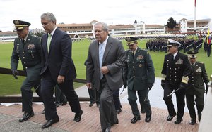 Colombia's President Ivan Duque, second left, and Defense Minister Guillermo Botero, center, accompanied by their military and police commanders attend a military ceremony in Bogotá, Colombia, Friday, June 7, 2019.