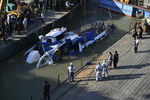 The sunk shipwreck surfaces during the recovery operation at Margaret Bridge, the scene of the fatal boat accident in Budapest, Hungary, Tuesday, June 11, 2019.