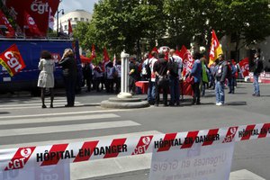 A ribbon reads "Hospital in danger" during a protest in front of the ministry of health, in Paris, Tuesday, June 11, 2019. French emergency medical staff are on strike to protest against poor working conditions in public hospitals.