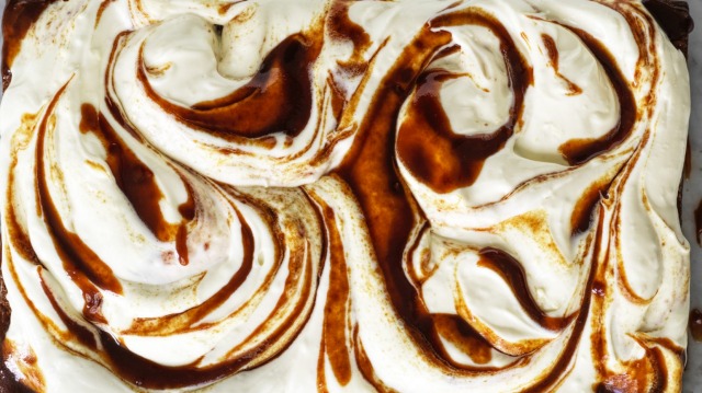 A slab of banana cake with cream cheese icing and swirls of optional  miso caramel.