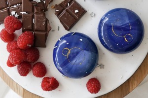 Galaxy chocolate mousse cake, featuring dark chocolate, raspberry and sour cherry confit and jasmine mousse.