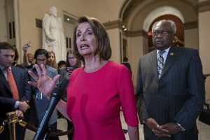 Speaker of the House Nancy Pelosi, D-Calif., center, joined at right by Majority Whip James Clyburn, D-S.C., pushes back on President Donald Trump's demand to fund a wall on the US-Mexico border with the partial government shutdown in its second week, at the Capitol in Washington, Thursday, Jan. 3, 2019.