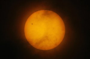 A tiny dot of the planet Venus is seen on the northwest side of the Sun's disc as viewed in Manila, Philippines, on a rare astronomical occasion Tuesday, June 8, 2004