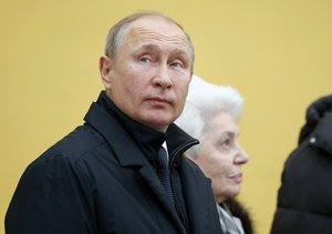 Russian President Vladimir Putin looks at a monument to the Nobel Prize-winning author Alexander Solzhenitsyn in Moscow, Russia, Tuesday, Dec. 11, 2018