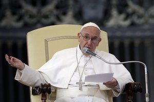 Pope Francis delivers his blessing as he arrives in St. Peter's Square for the weekly general audience, at the Vatican, Wednesday, Oct. 14, 2015.