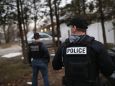 Customs and Border Protection officers watch a house