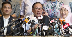 Malaysia’s prime minister-in-waiting Anwar Ibrahim, center, speaks next to his wife Deputy Prime Minister Wan Azizah Wan Ismail, right, and Minister of Economic Affairs Mohamed Azmin Ali, during a press conference at the People's Justice Party headquarters in Petaling Jaya, Malaysia, Friday, Sept. 21, 2018. Anwar said that he has no reason to doubt his former political nemesis will hand over the leadership position within two years as planned after sorting out deep-seated issues like corruption. (AP Photo/Yam G-Jun)