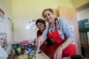 Two women are busy cooking a curry