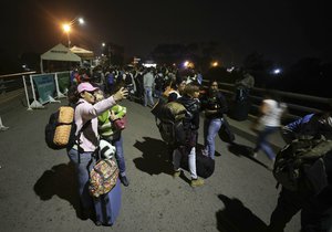 Women take selfie as they arrive to La Parada, on the outskirts of Cucuta, Colombia, on the border with Venezuela, Tuesday, Feb. 5, 2019