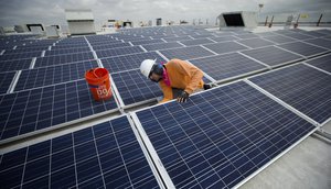 Neil Black works on the installation of South Florida’s largest solar panel array atop the future IKEA store in Miami, Wednesday, April 16, 2014.