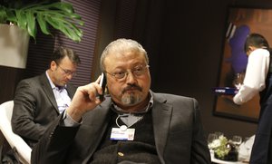 In this Jan. 29, 2011, file photo, Saudi Arabian journalist Jamal Khashoggi speaks on his cellphone at the World Economic Forum in Davos, Switzerland