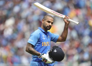 India's Shikhar Dhawan acknowledges the applause from the crowd as he leaves the field after losing his wicket during the Cricket World Cup match between Australia and India at The Oval in London, Sunday, June 9, 2019.