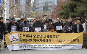 FILE - In this Nov. 29, 2018, file photo, victims of Japan's forced labor and their family members arrive at the Supreme Court in Seoul, South Korea.