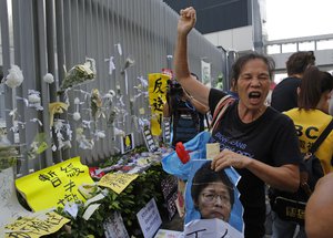 A protesters shout slogan demanding Hong Kong Chief Executive Carrie Lam to step down outside government office in Hong Kong, Tuesday, June 18, 2019.