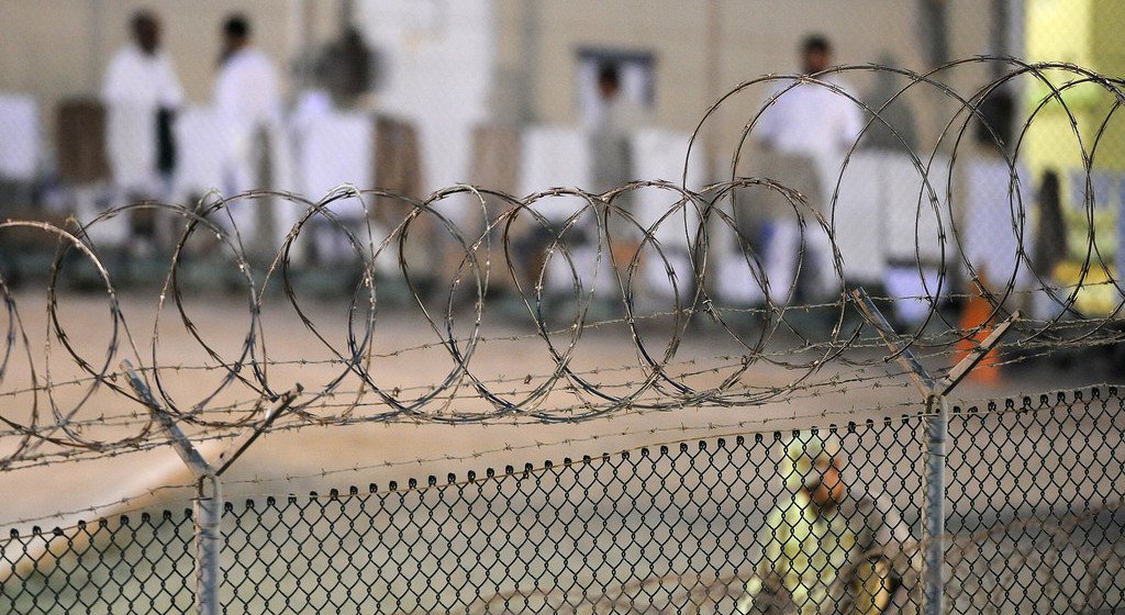 GUANTANAMO BAY, Cuba  A Navy guard assigned to Joint Task Force Guantanamos Navy Expeditionary Guard Battalion patrols Camp Deltas recreation yard during the early morning of July 7, 2010. (JTF Guantanamo photo by U.S. Air Force Tech. Sgt. Michael R. Holzworth)