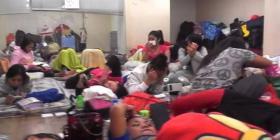 Crowded "dormitory" provided by agency company in Hong Kong, with workers sleepi