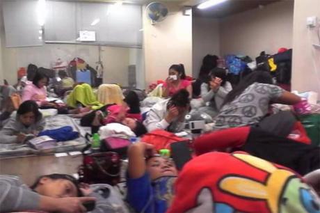 Crowded "dormitory" provided by agency company in Hong Kong, with workers sleepi