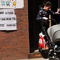 A sign warns of measles in the Orthodox Jewish community of Williamsburg, Brooklyn, in New York City, April 10, 2019. (Spencer Platt/Getty Images via JTA)