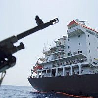 Sailors stand on deck above a hole the US Navy says was made by a limpet mine on the damaged Panama-flagged, Japanese owned oil tanker Kokuka Courageous, anchored off Fujairah, United Arab Emirates, June 19, 2019. (AP Photo/Fay Abuelgasim)