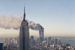 FILE - In this Sept. 11, 2001 file photo the twin towers of the World Trade Center burn behind the Empire State Building in New York after terrorists crashed two planes into the towers causing both to collapse. The government is preparing to release a once-classified chapter of a congressional report about the attacks of Sept. 11, that questions whether Saudi nationals who helped the hijackers with things like finding apartments and opening bank accounts knew what they were planning. House Minority Leader Nancy Pelosi said Friday July 15, 2016, that the release of the 28-page chapter is