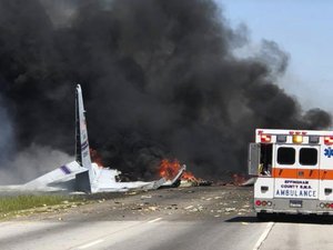 Flames and smoke rise from an Air National Guard C-130 cargo plane after it crashed near Savannah, Ga., Wednesday, May 2, 2018.