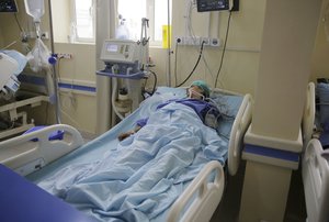 A Yemeni woman who was injured in an explosion lies in a bed at a hospital in Sanaa, Yemen, Sunday, April 7, 2019.