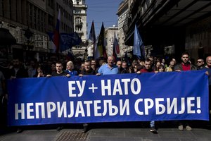 Vojislav Seselj, center, the leader of the ultranationalist Serbian Radical Party, and his supporters, march along a street during a protest in Belgrade, Serbia, Sunday, March 24, 2019.