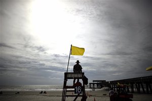 Tybee Island Ocean Rescue Senior Lifeguard Jerry Hazellief watches for rip currents from Hurricane Arthur from his lifeguard tower on the beach on Tybee Island, Ga., Thursday, July 3, 2014.