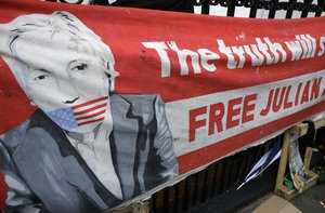 A poster displayed on the railings outside the Ecuadorian Embassy in London, after WikiLeaks founder Julian Assange was arrested by officers from the Metropolitan Police and taken into custody Thursday April 11, 2019