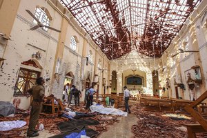 Dead bodies of victims lie inside St. Sebastian's Church damaged in blast in Negombo, north of Colombo, Sri Lanka, Sunday, April 21, 2019