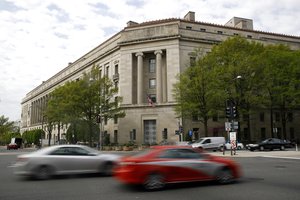 Traffic passes the Department of Justice building, Wednesday, April 17, 2019, in Washington. (AP Photo/Patrick Semansky)